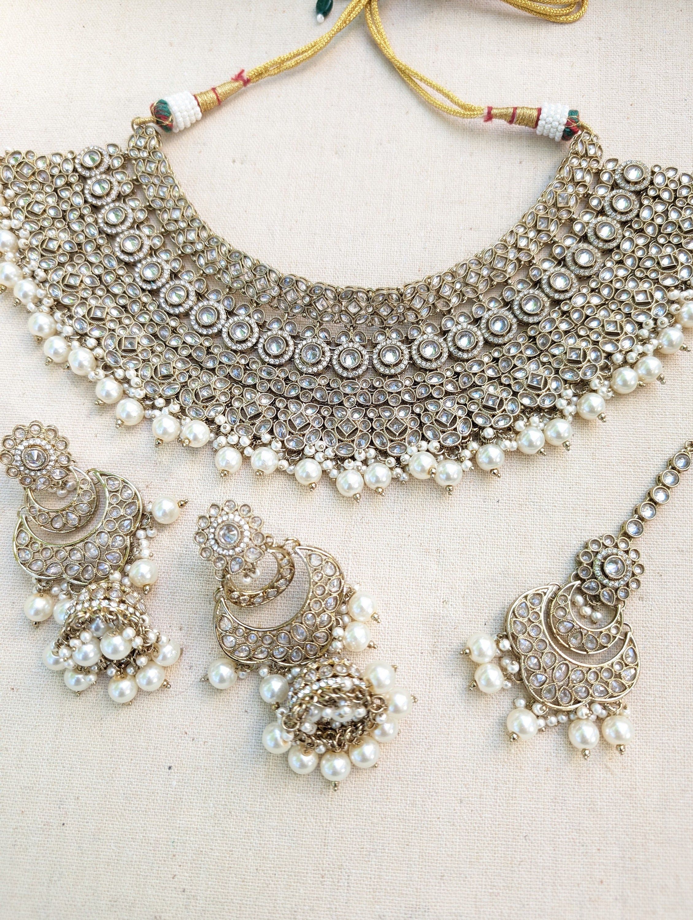 Antique Gold necklace set with chandbali earrings and tikka. Polki choker necklace set. Indian wedding jewelry. Pakistani wedding jewelry. Bollywood necklace set. Punjabi jewelry set. Kundan necklace jhumka. Antique gold-plated necklace. Champagne stones.