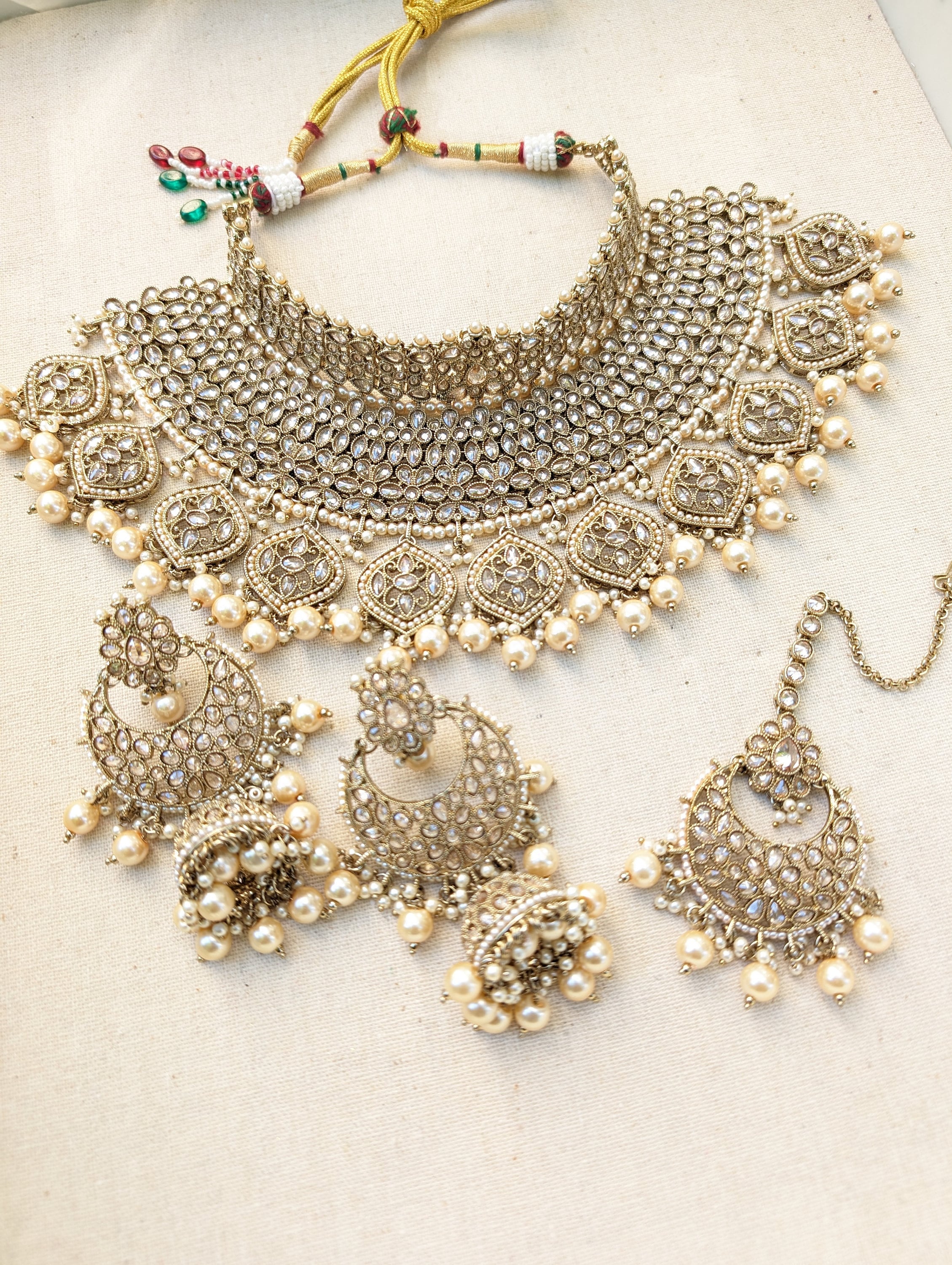 Gold necklace set with chandbali earrings and tikka. Polki choker necklace set. Indian wedding jewelry. Pakistani wedding jewelry. Bollywood necklace set. Punjabi jewelry set. Kundan necklace jhumka. Antique gold-plated necklace. Champagne stones.