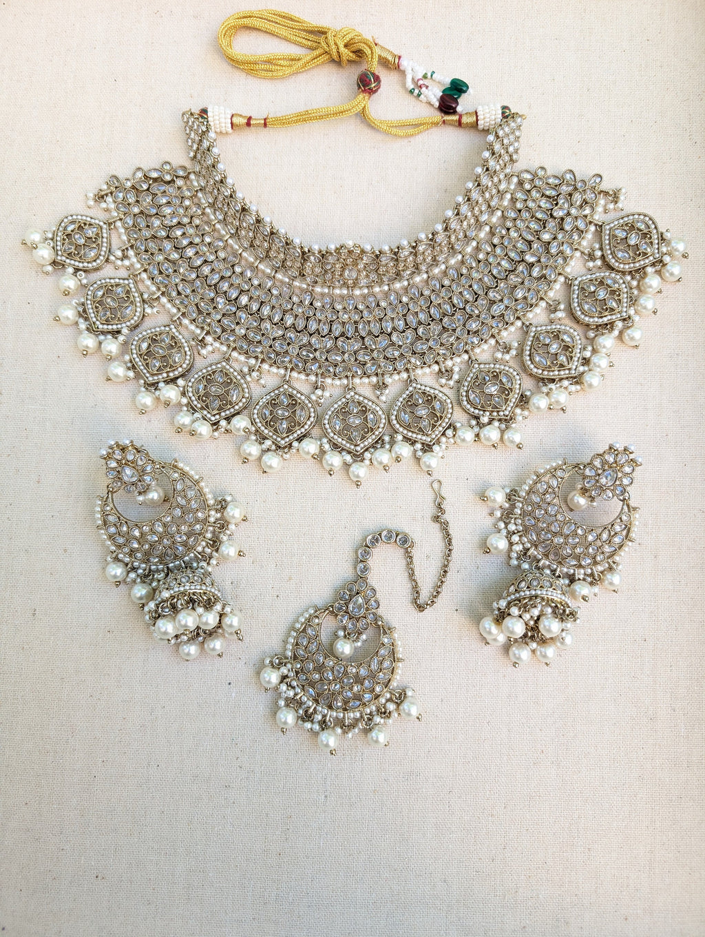 Antique Gold necklace set with chandbali earrings and tikka. Polki choker necklace set. Indian wedding jewelry. Pakistani wedding jewelry. Bollywood necklace set. Punjabi jewelry set. Kundan necklace jhumka. Antique gold-plated necklace. Champagne stones.