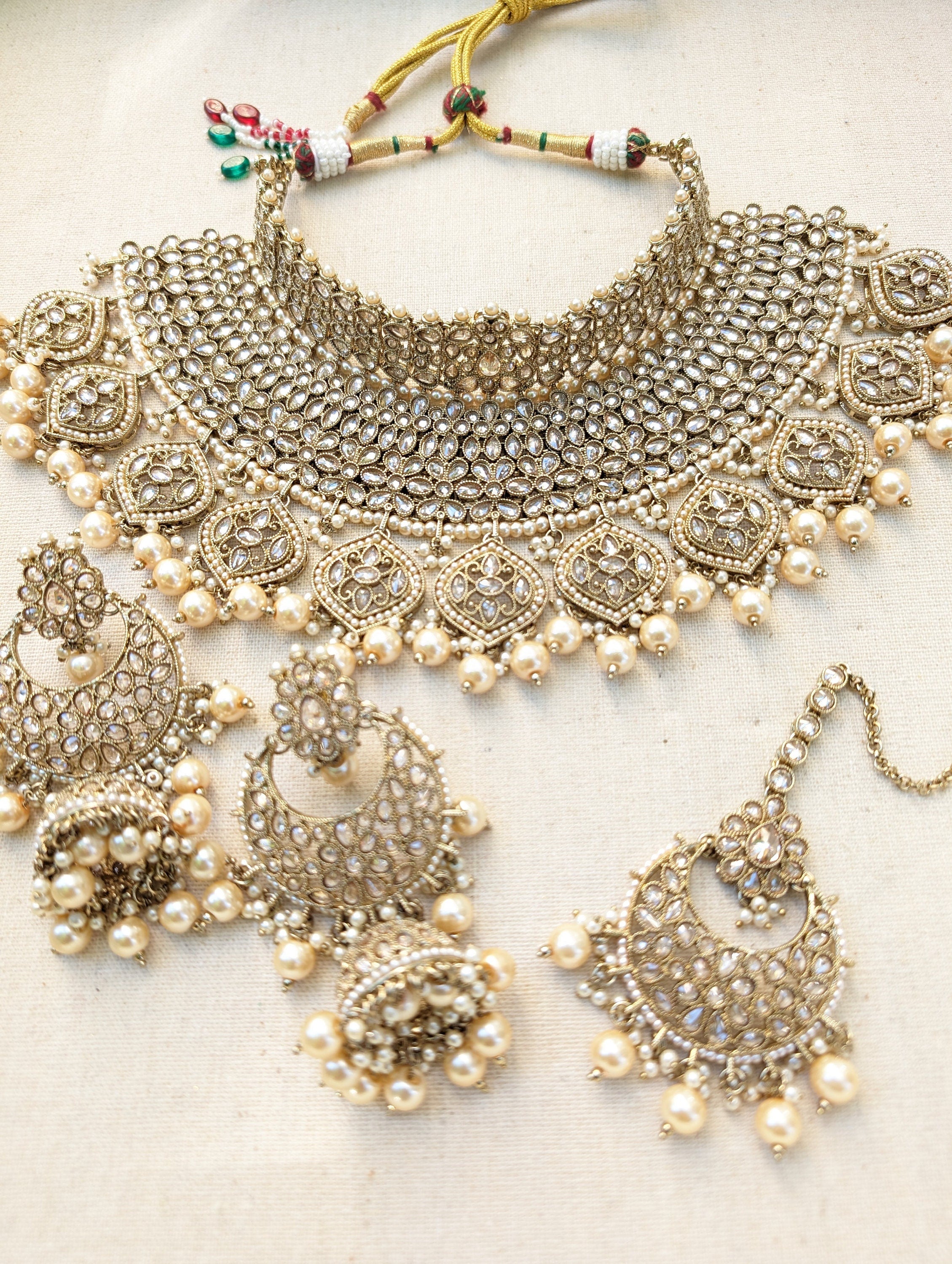 Gold necklace set with chandbali earrings and tikka. Polki choker necklace set. Indian wedding jewelry. Pakistani wedding jewelry. Bollywood necklace set. Punjabi jewelry set. Kundan necklace jhumka. Antique gold-plated necklace. Champagne stones.