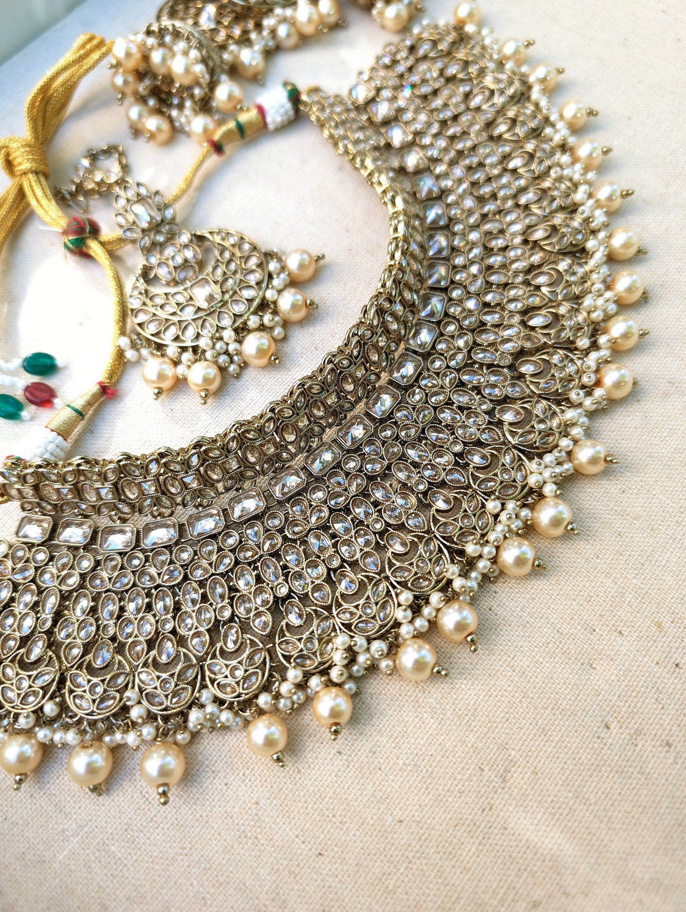 Gold necklace set with chandbali earrings and tikka. Polki choker necklace set. Indian wedding jewelry. Pakistani wedding jewelry. Bollywood necklace set. Punjabi jewelry set. Kundan necklace jhumka. Antique gold-plated necklace. Champagne stones.