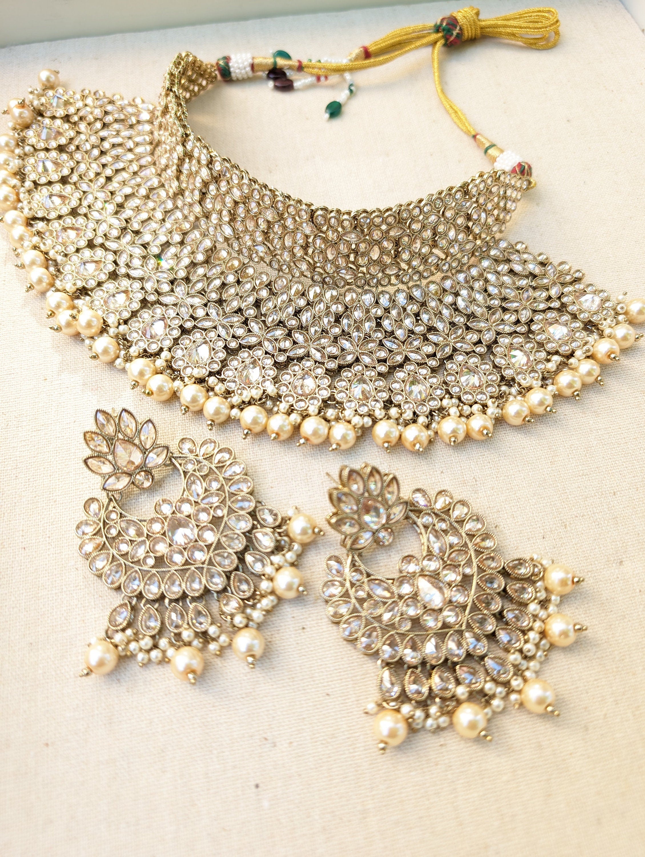 Gold necklace set with chandbali earrings and tikka. Polki choker necklace set. Indian wedding jewelry. Pakistani wedding jewelry. Bollywood necklace set. Punjabi jewelry set. Kundan necklace jhumka. Antique gold-plated necklace. Champagne stones.