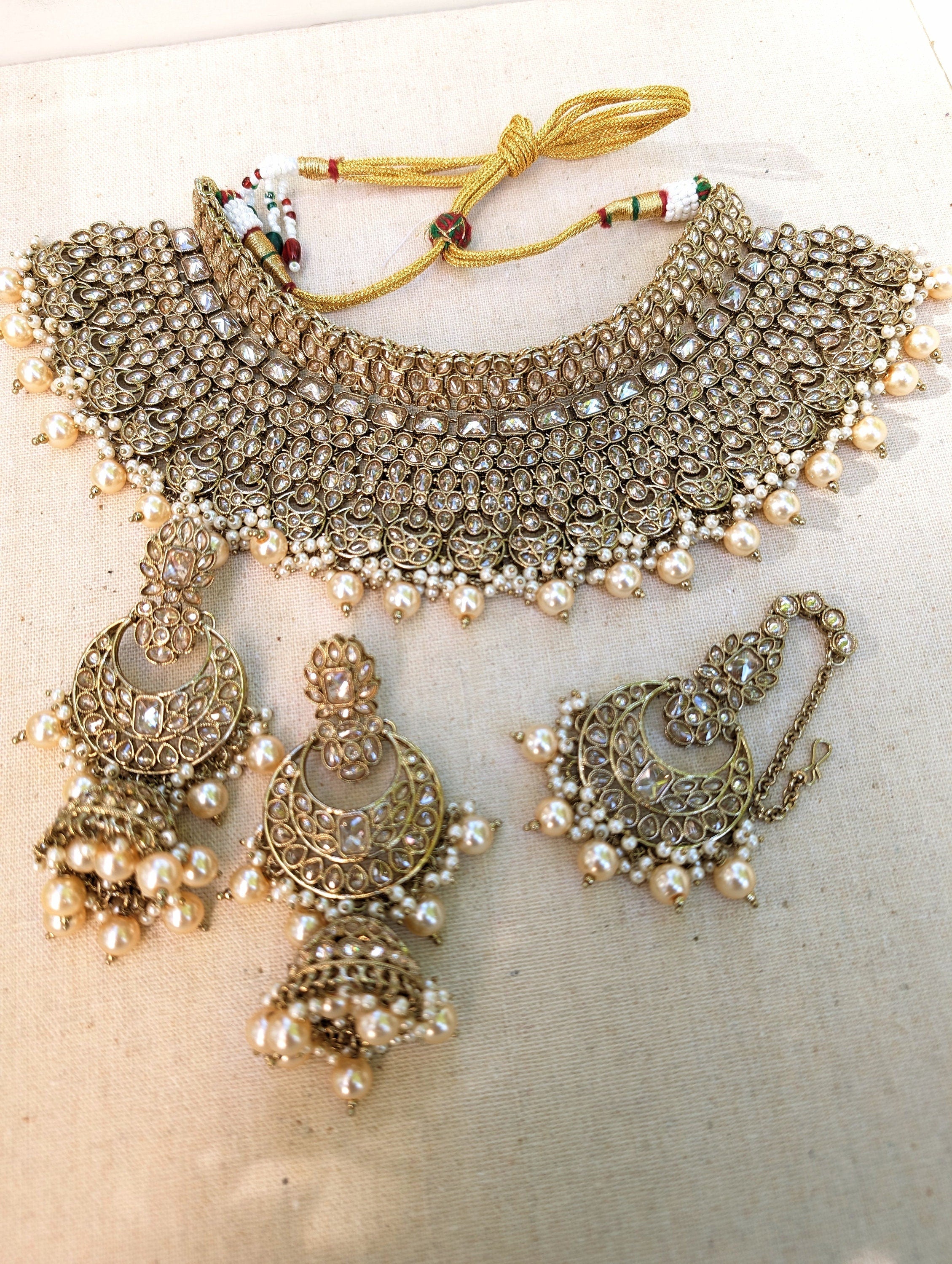 Gold necklace set with chandbali earrings and tikka. Polki choker necklace set. Indian wedding jewelry. Pakistani wedding jewelry. Bollywood necklace set. Punjabi jewelry set. Kundan necklace jhumka. Antique gold-plated necklace. Champagne stones.