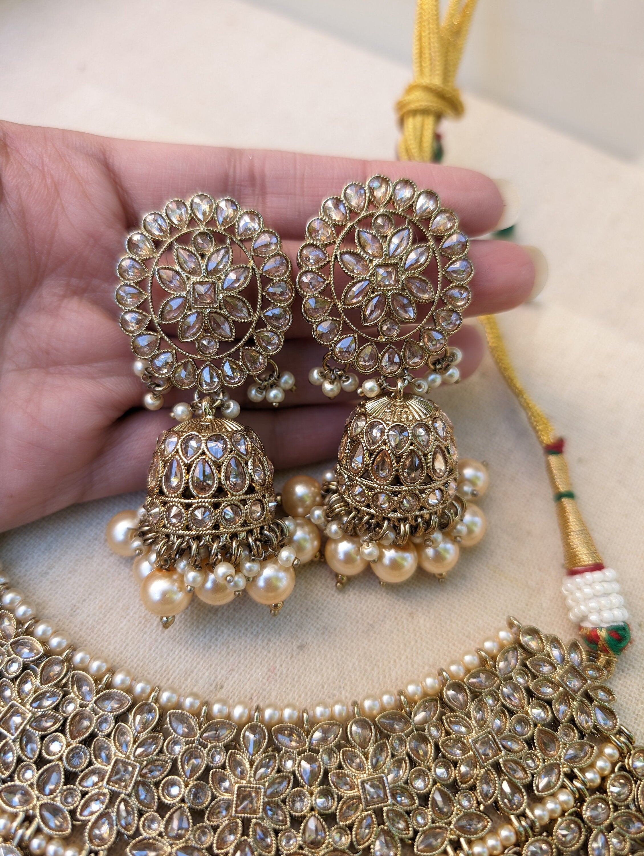 Gold necklace set with chandbali earrings and tikka. Polki choker necklace set. Indian wedding jewelry. Pakistani wedding jewelry. Bollywood necklace set. Punjabi jewelry set. Kundan necklace jhumka. Antique gold-plated necklace. Champagne stones.