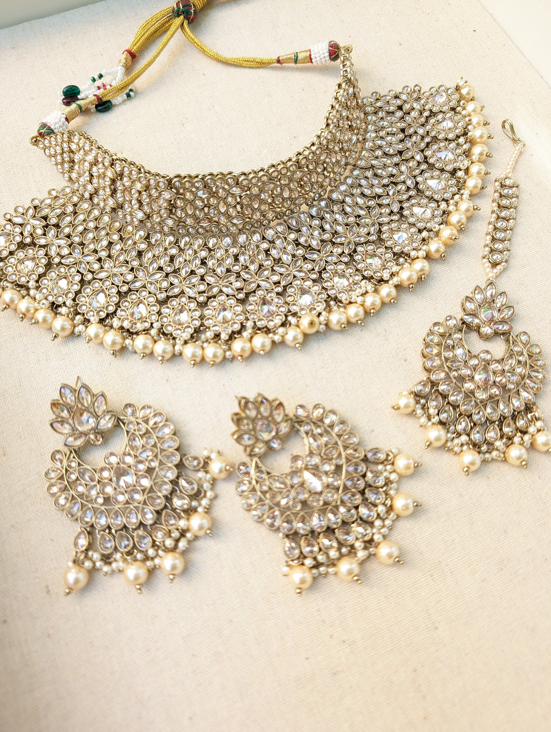 Gold necklace set with chandbali earrings and tikka. Polki choker necklace set. Indian wedding jewelry. Pakistani wedding jewelry. Bollywood necklace set. Punjabi jewelry set. Kundan necklace jhumka. Antique gold-plated necklace. Champagne stones.