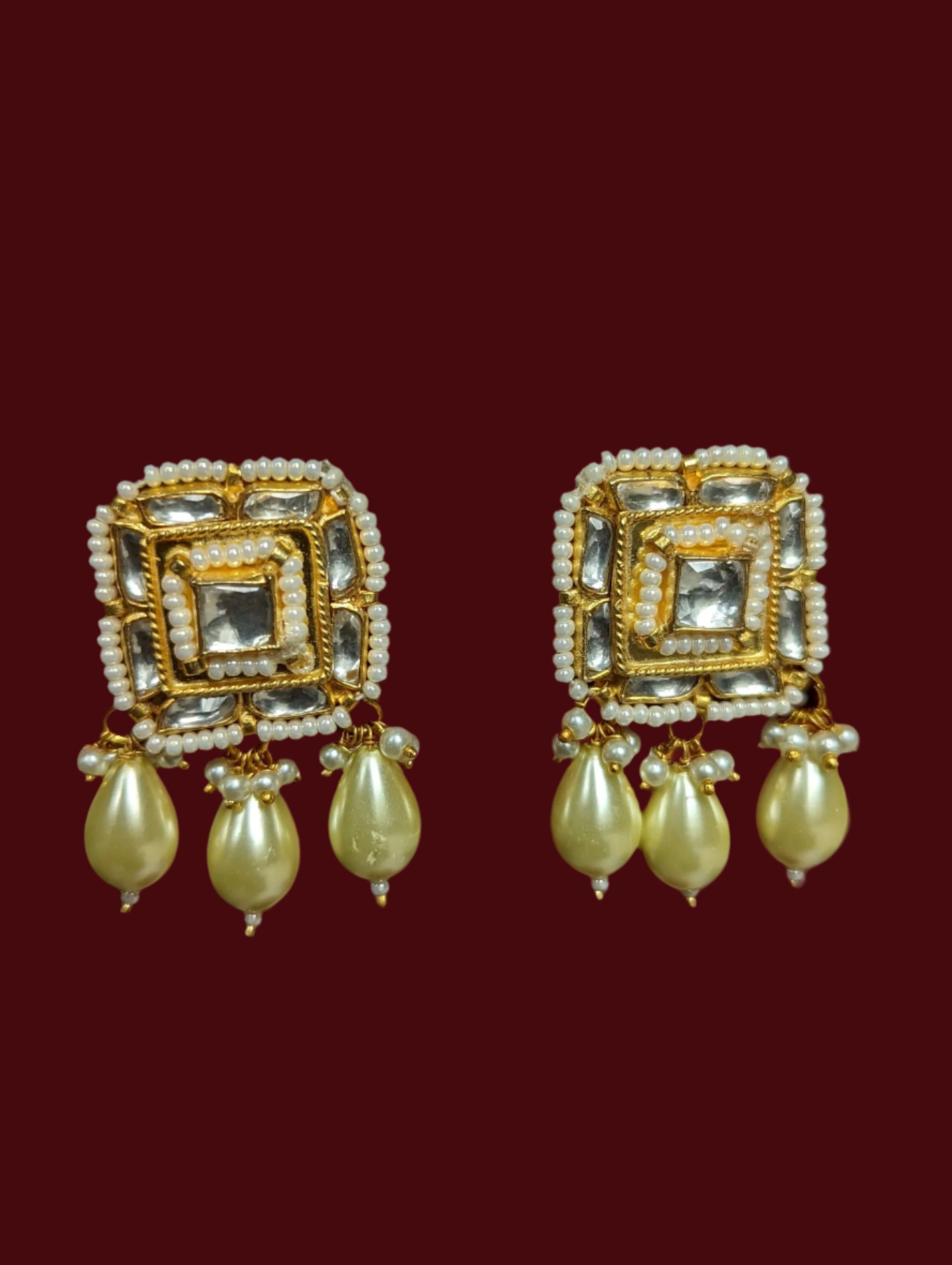 These are gold plated handmade kundan stud earrings with faux pearls.