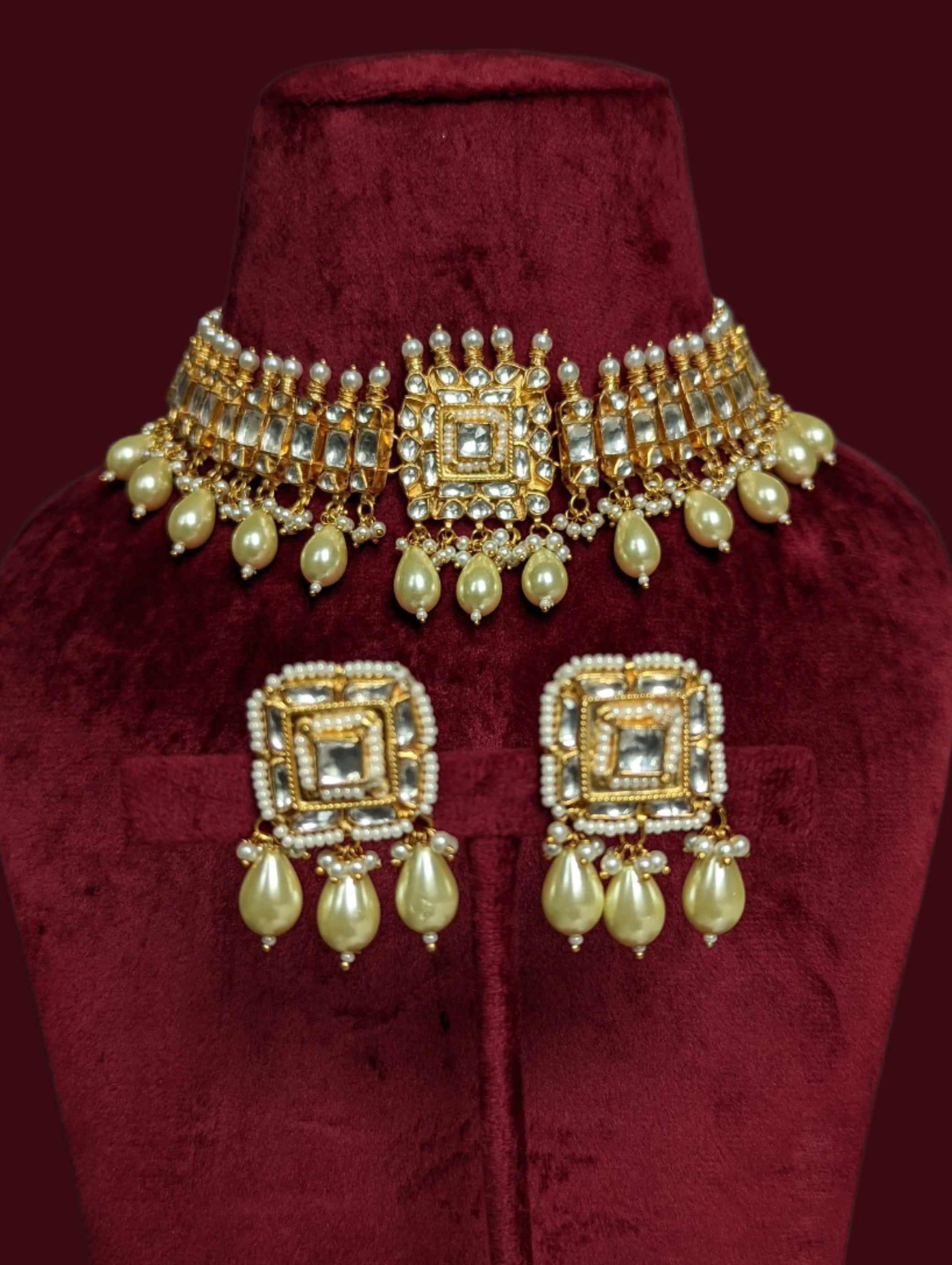 This is a gold plated handmade kundan choker necklace with matching stud earrings.