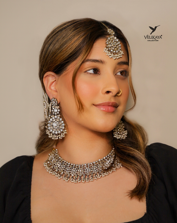 Woman wearing silver Indian necklace with earrings