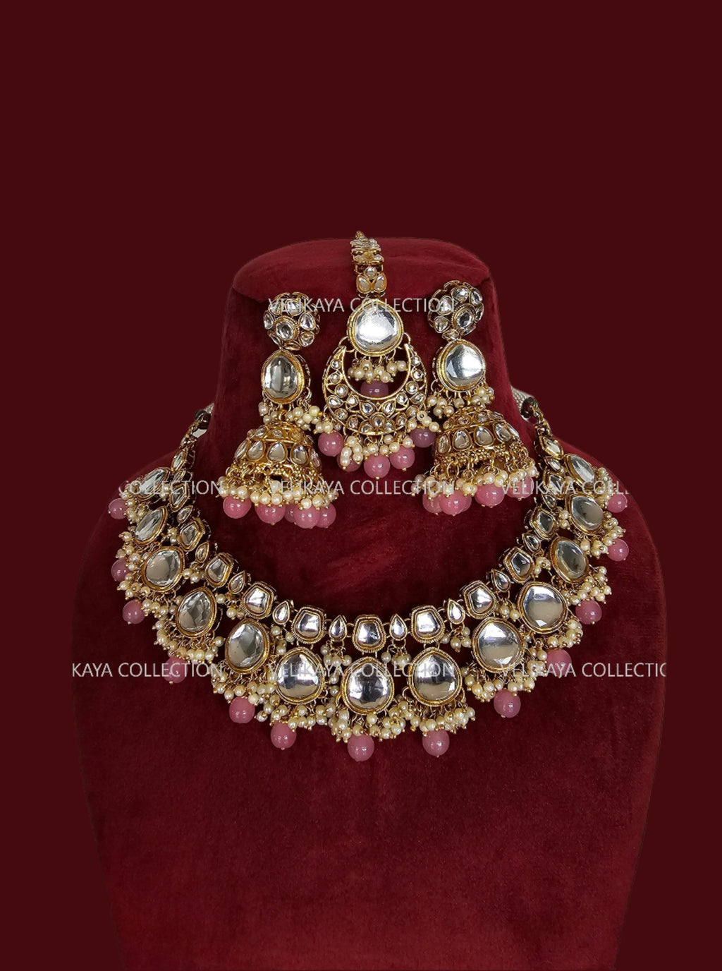 Gold kundan necklace set with pink beads, earrings and tikka for Indian weddings.