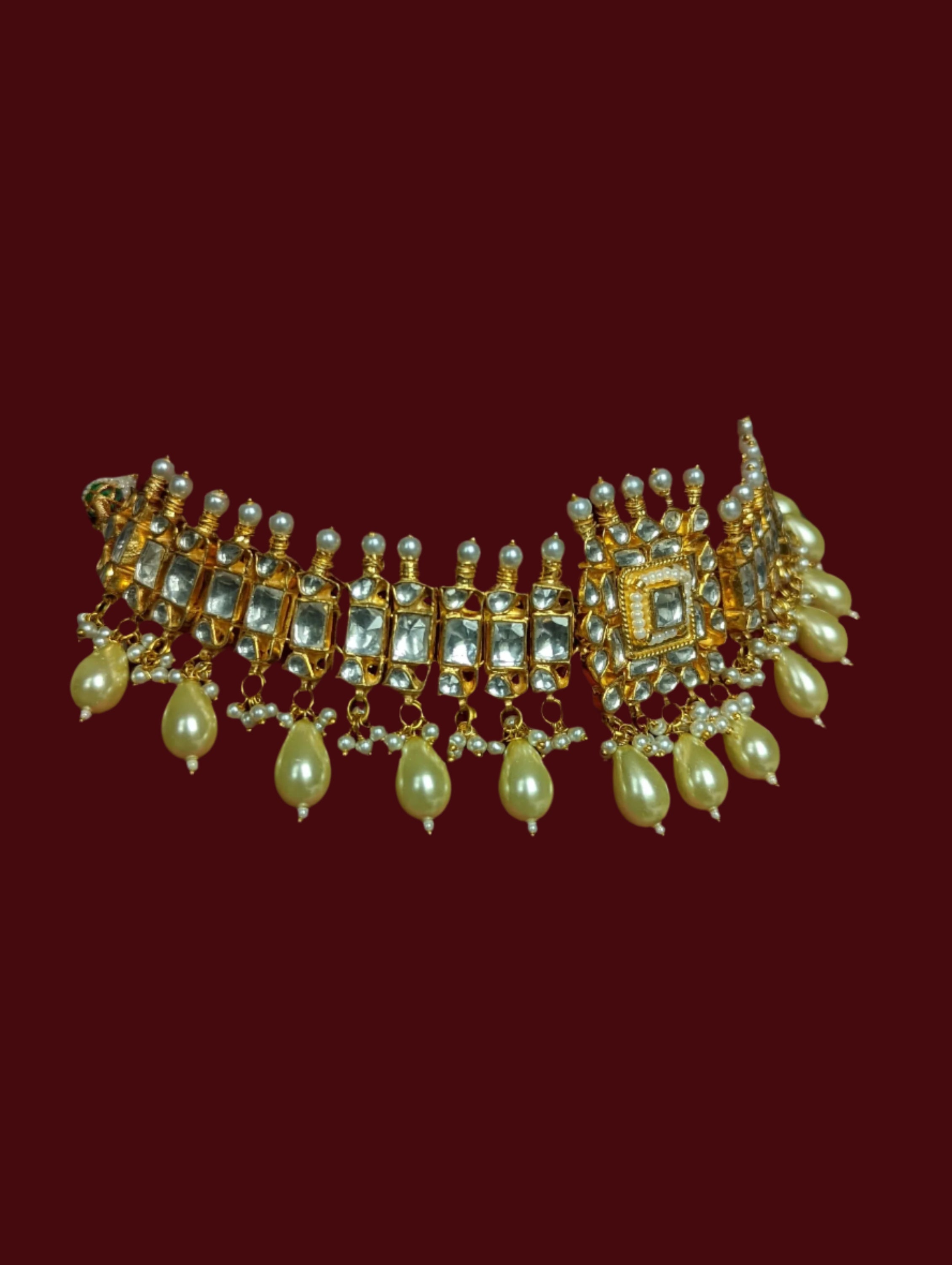 This is a gold plated handmade kundan choker necklace with matching stud earrings.