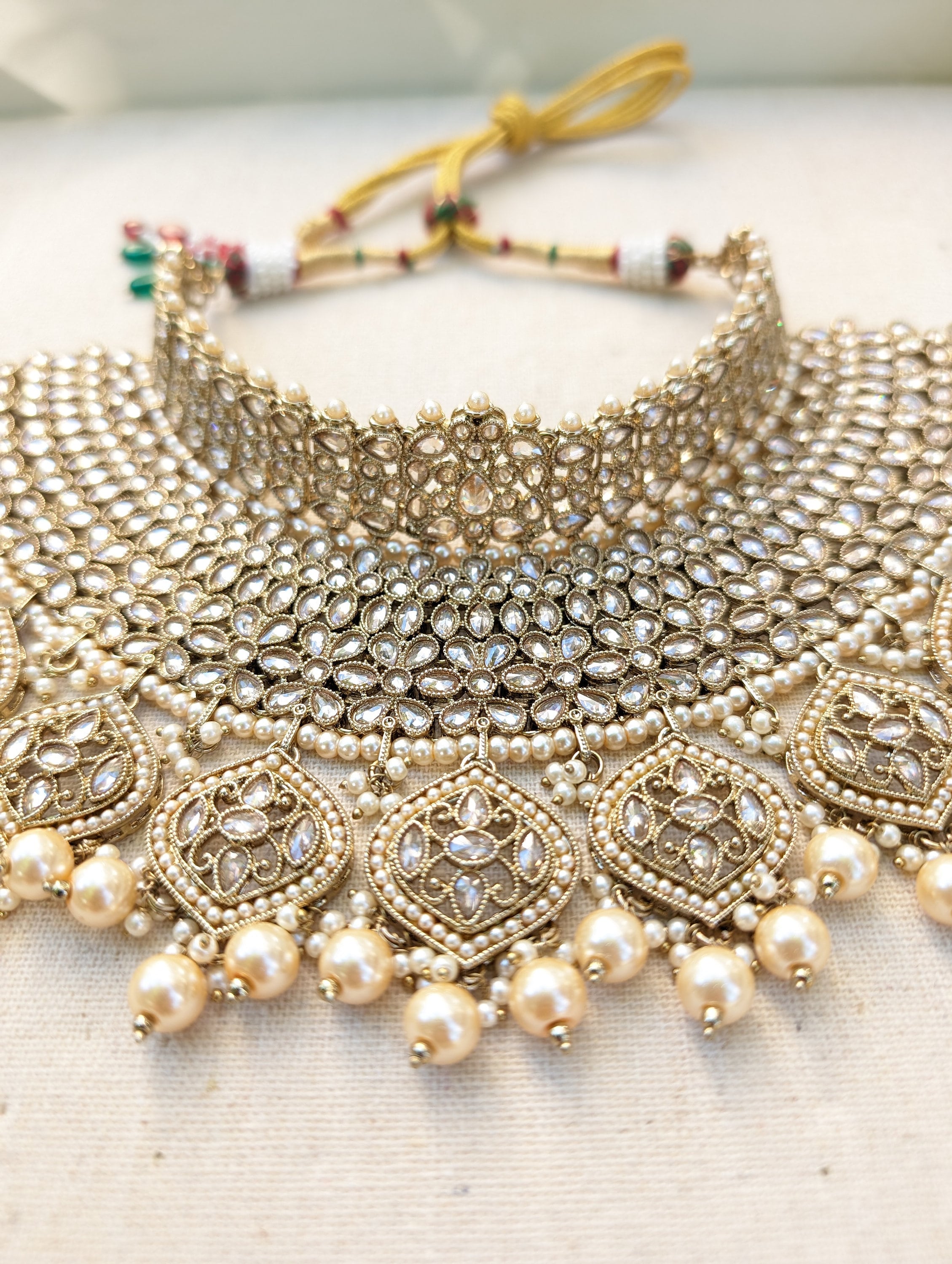 Gold necklace set with chandbali earrings and tikka. Polki choker necklace set. Indian wedding jewelry. Pakistani wedding jewelry. Bollywood necklace set. Punjabi jewelry set. Kundan necklace jhumka. Antique gold-plated necklace. Champagne stones.