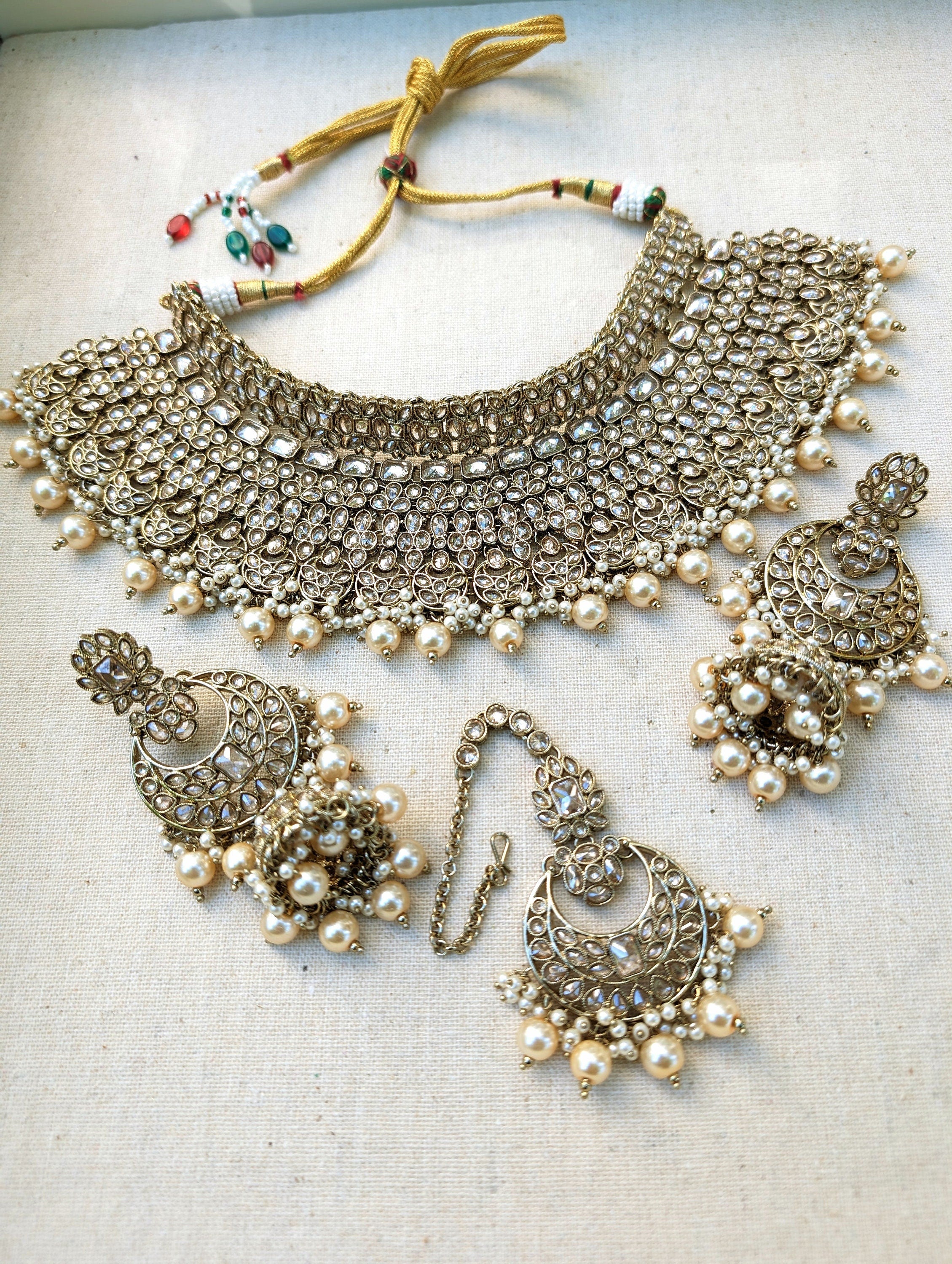 Gold necklace set with chandbali earrings and tikka. Polki choker necklace set. Indian wedding jewelry. Pakistani wedding jewelry. Bollywood necklace set. Punjabi jewelry set. Kundan necklace jhumka. Antique gold-plated necklace. Champagne stones.