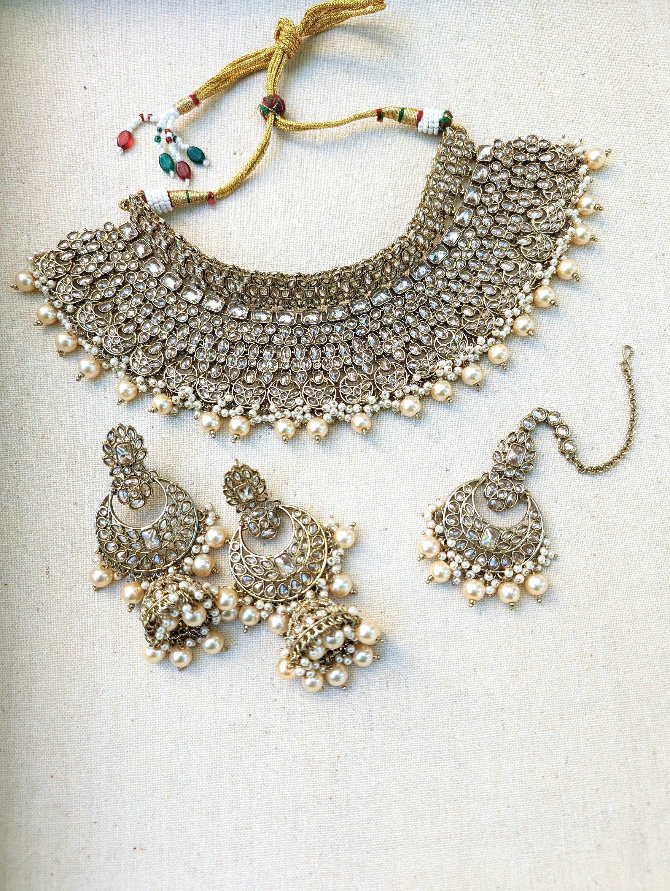 Gold necklace set with chandbali earrings and tikka. Polki choker necklace set. Indian wedding jewelry. Pakistani wedding jewelry. Bollywood necklace set. Punjabi jewelry set. Kundan necklace jhumka. Antique gold-plated necklace. Champagne stones.