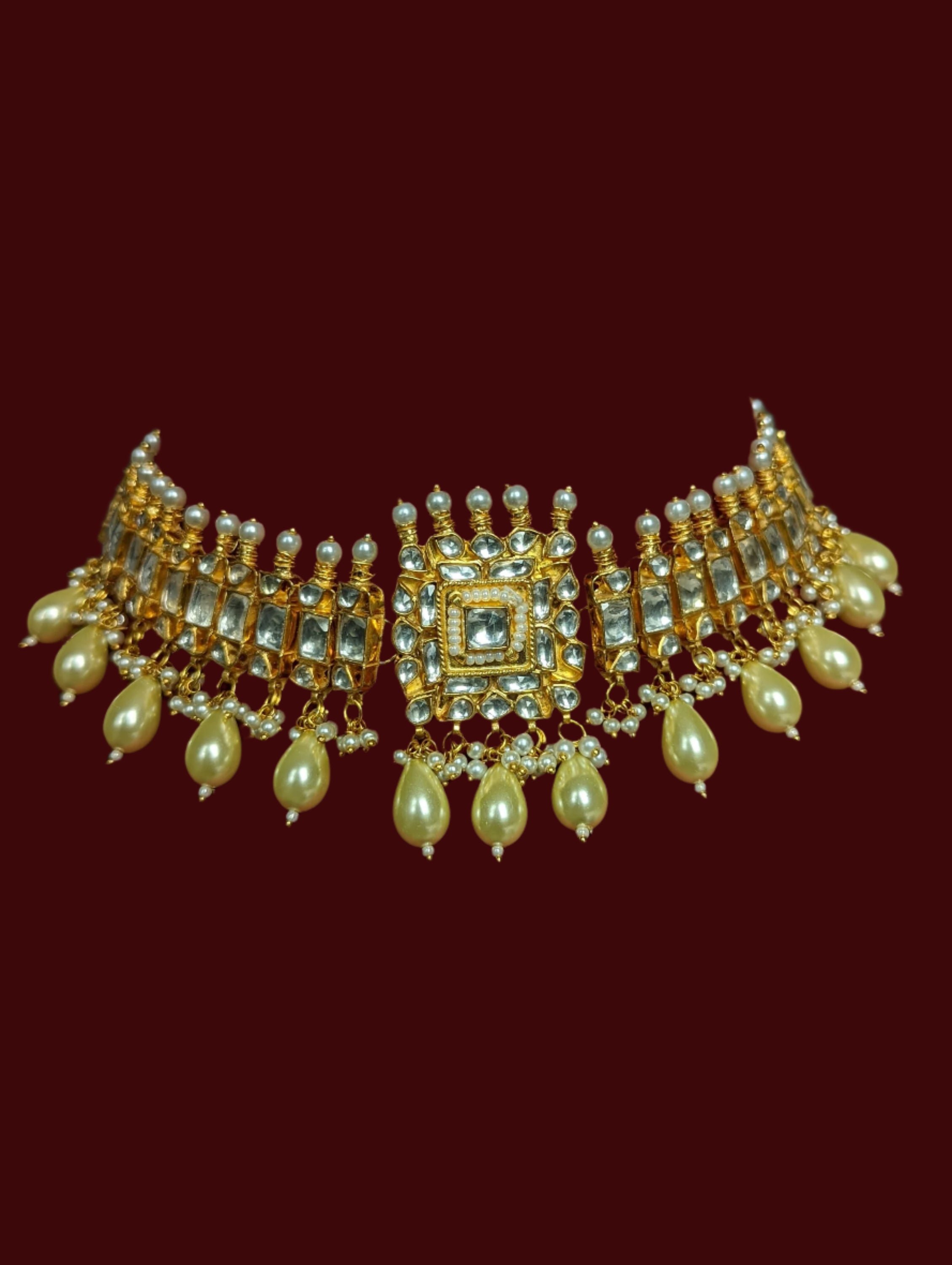 This is a gold plated handmade kundan choker necklace with matching stud earrings.