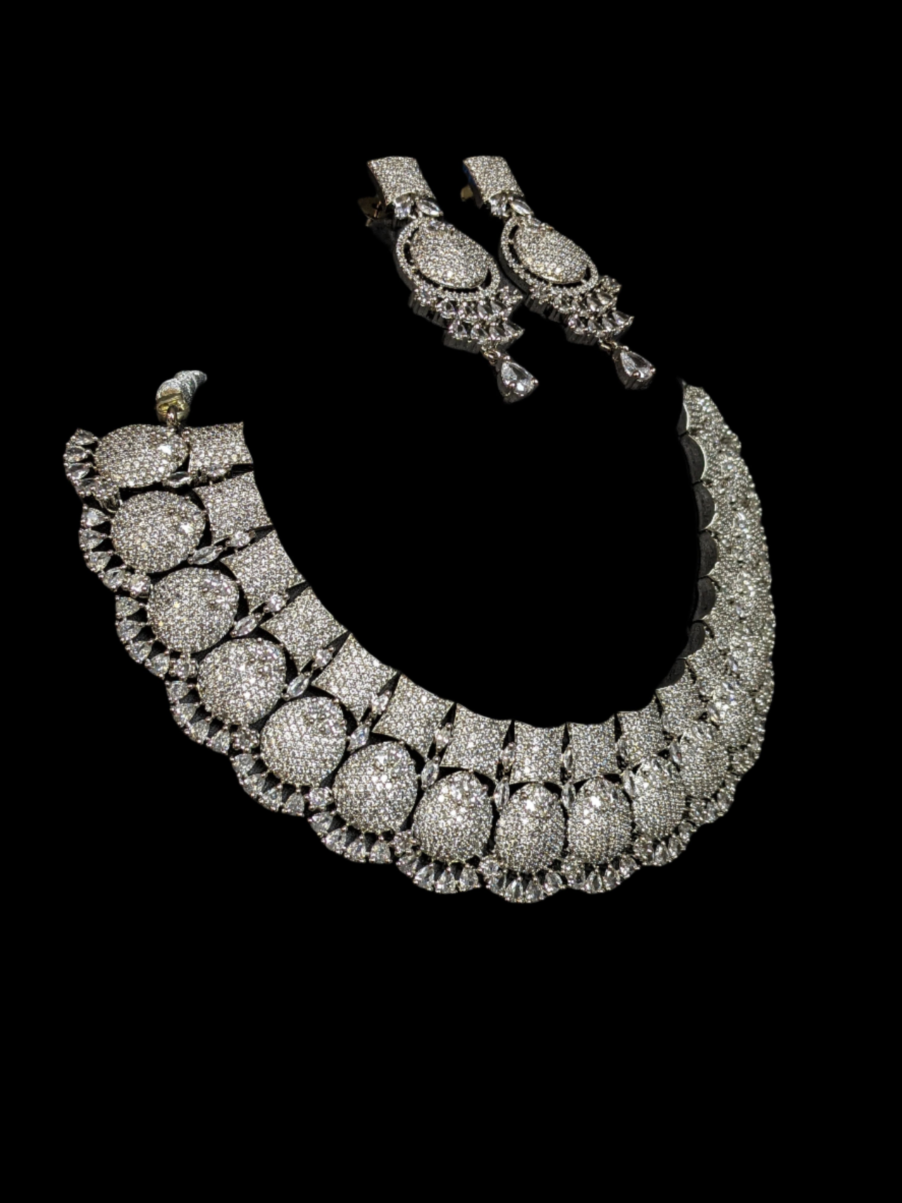 This is silver plated american diamond necklace with statement earrings for weddings and parties.